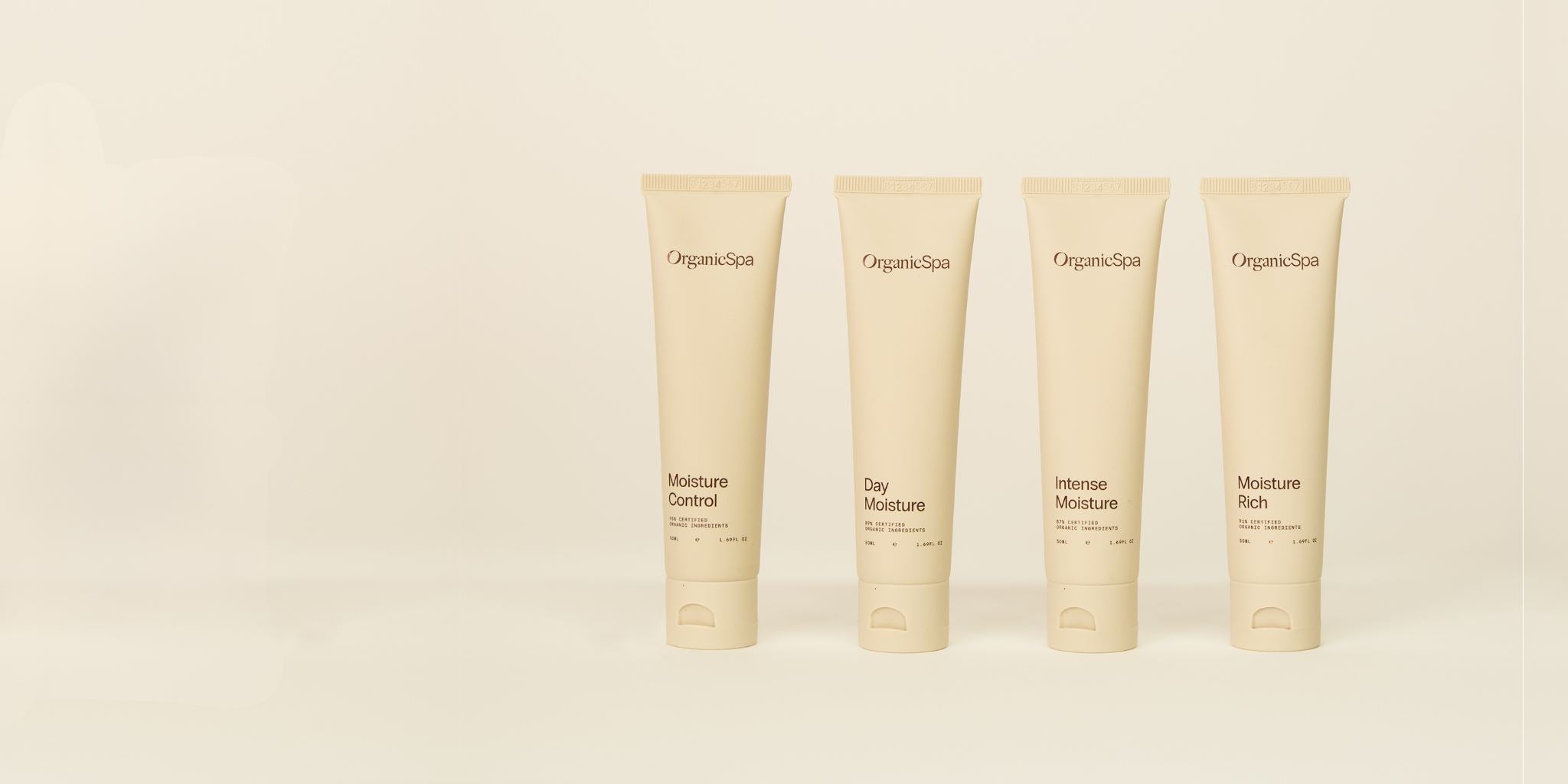 A collection of four OrganicSpa moisturisers, including Moisture Control and Moisture Rich, displayed in their earthy, nature-inspired Beige Tint packaging.