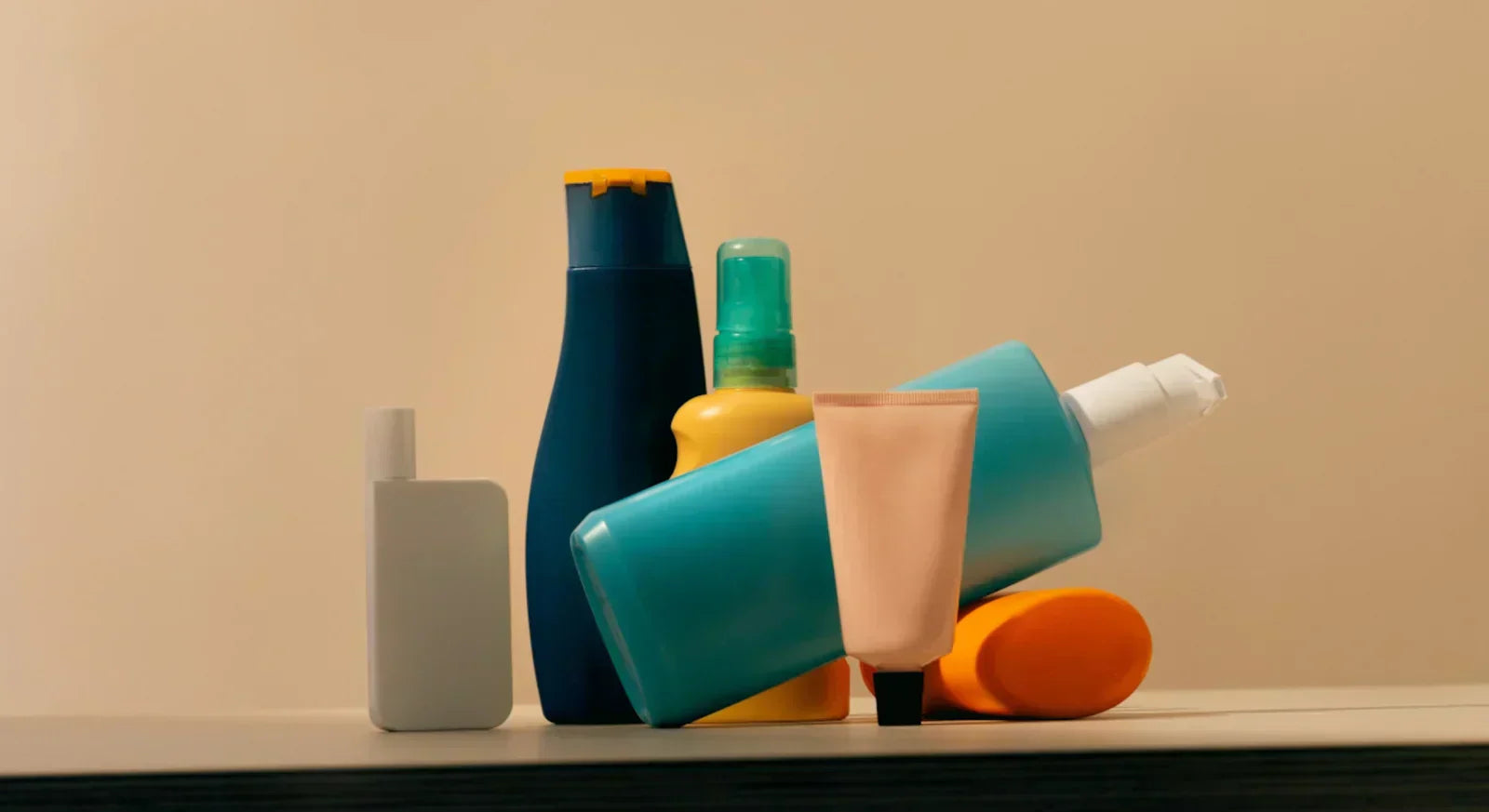 Colourful collection of plastic packaging products on a beige background