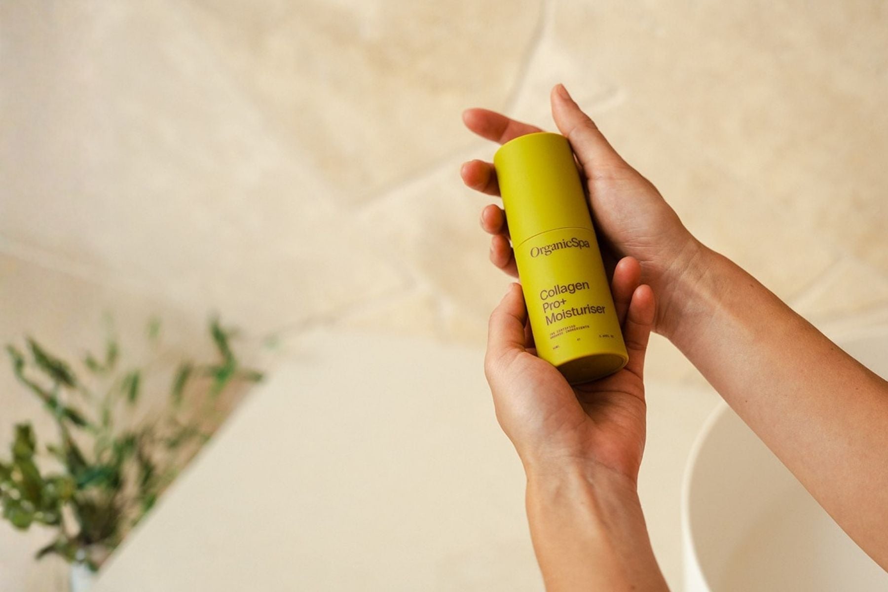 OrganicSpa Collagen Pro+ Moisturiser held in hands, hydrating anti-ageing skincare