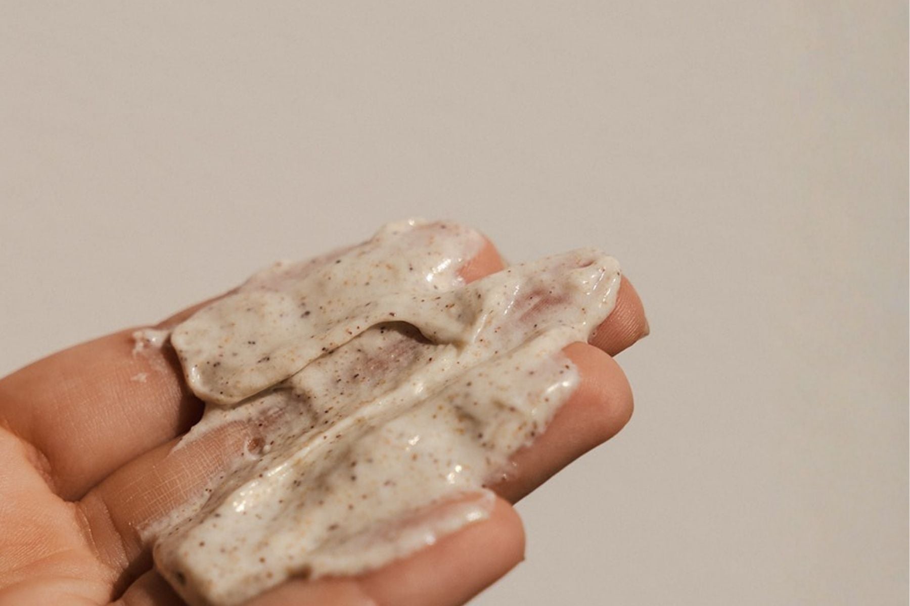 Close-up of Organic Spa face exfoliant texture on fingertips