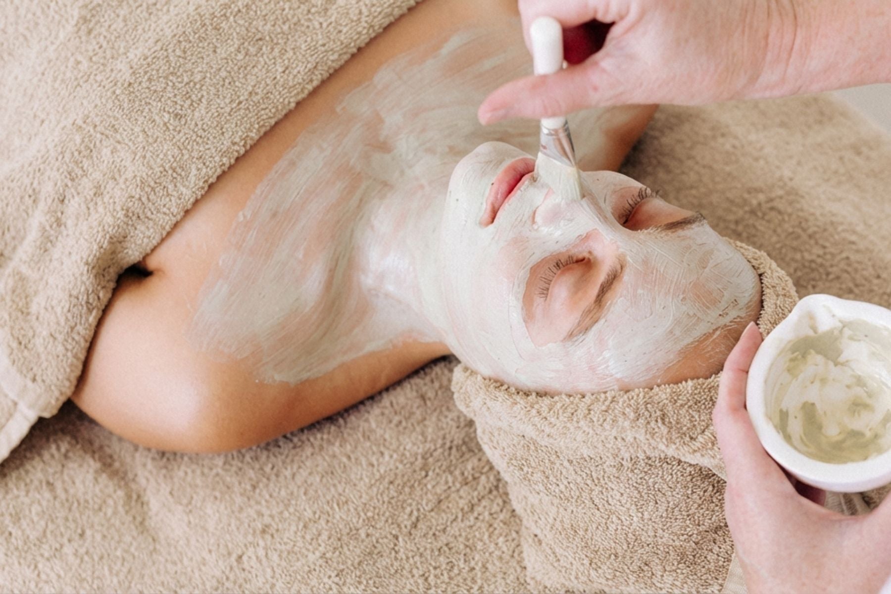 Spa facial treatment with Organic Spa mask applied by brush.