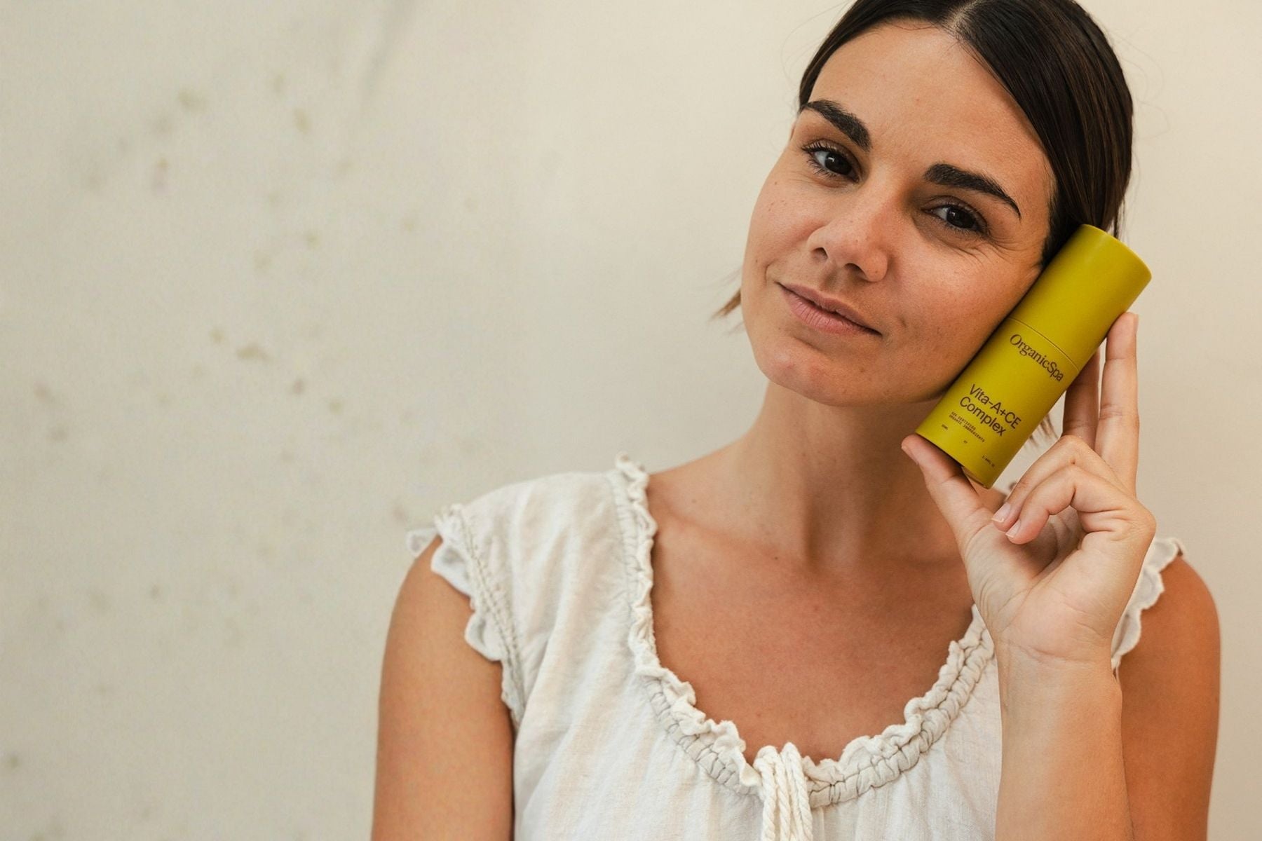 Woman holding OrganicSpa Vita-A+CE Complex serum