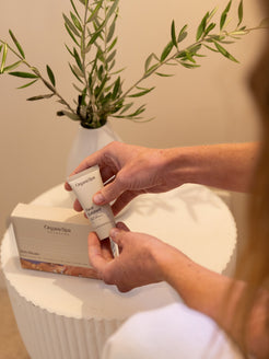 Hand holding OrganicSpa Face Exfoliant from the Rich Rituals set, a Certified Organic skincare collection for drier, mature complexions.