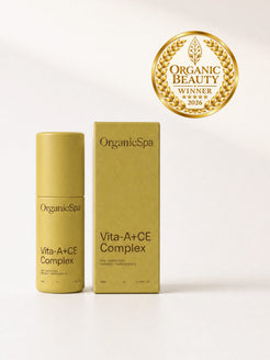 OrganicSpa Vita-A+CE Complex, a chartreuse 50ml bottle standing beside its matching carton, both marked 93% certified organic ingredients. Gold laurel badge beside them: Organic Beauty winner 2026.