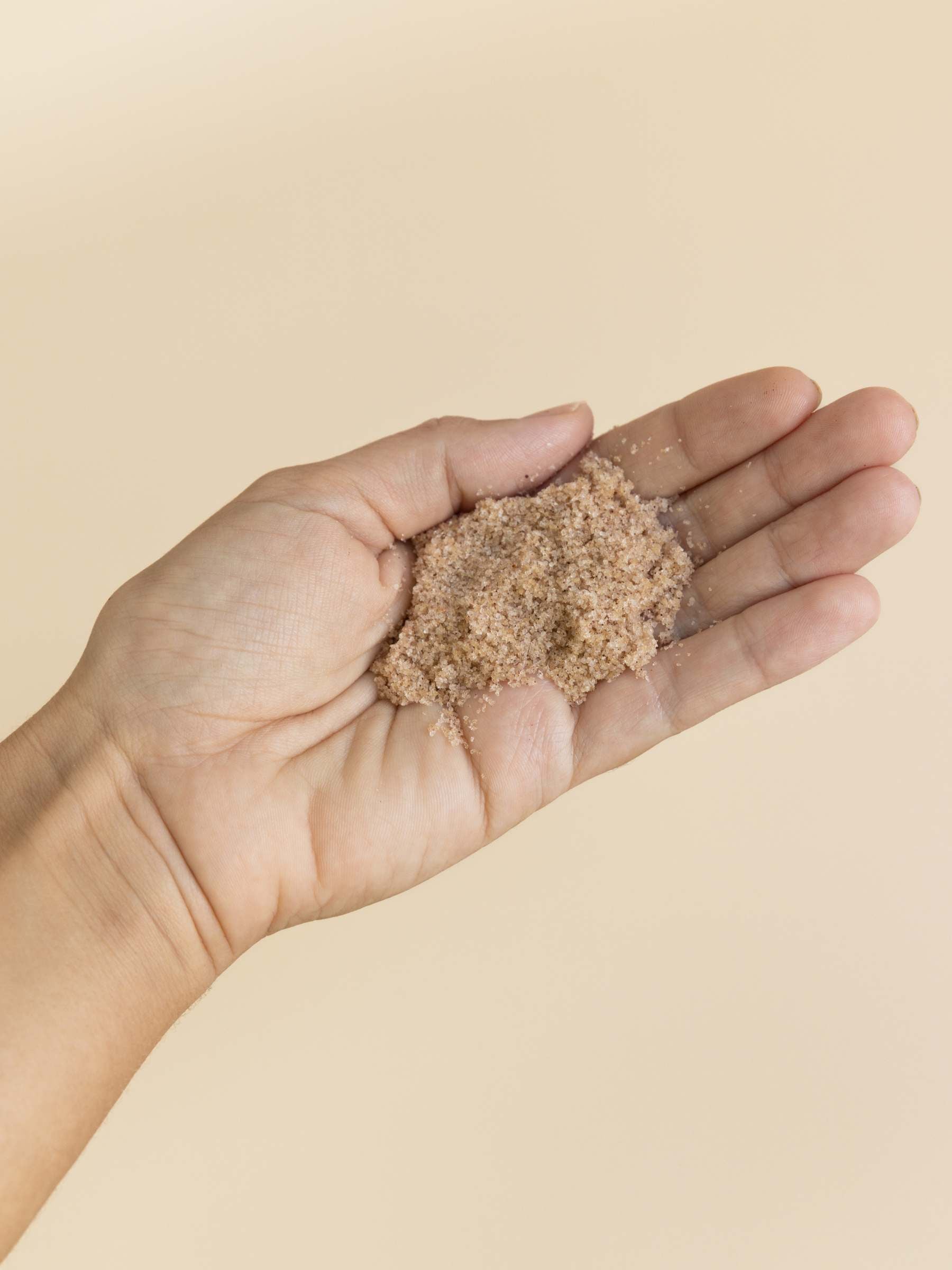 A handful of OrganicSpa Refining Mineral Salts — a finely milled Certified Organic body scrub with Australian and Himalayan salts.