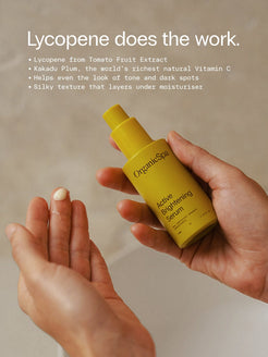 OrganicSpa Active Brightening Serum, a chartreuse 30ml bottle held in one hand with a drop of the serum on a fingertip. Lycopene does the work. Lycopene from Tomato Fruit Extract. Kakadu Plum, the world’s richest natural Vitamin C. Helps even the look of tone and dark spots. Silky texture that layers under moisturiser.