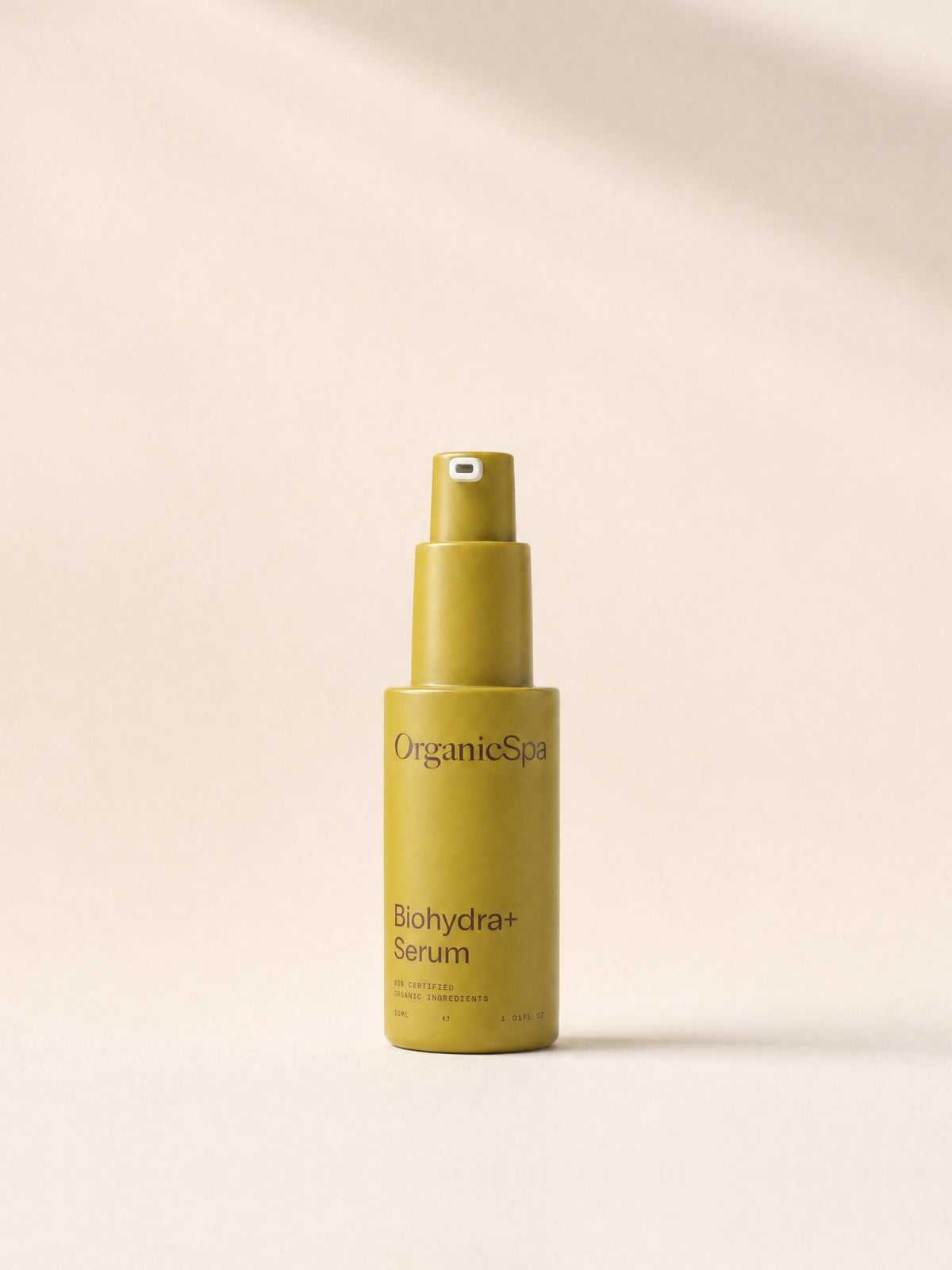 OrganicSpa Biohydra+ Serum, a chartreuse 30ml pump bottle marked 93% Certified Organic Ingredients, on a plain cream background.