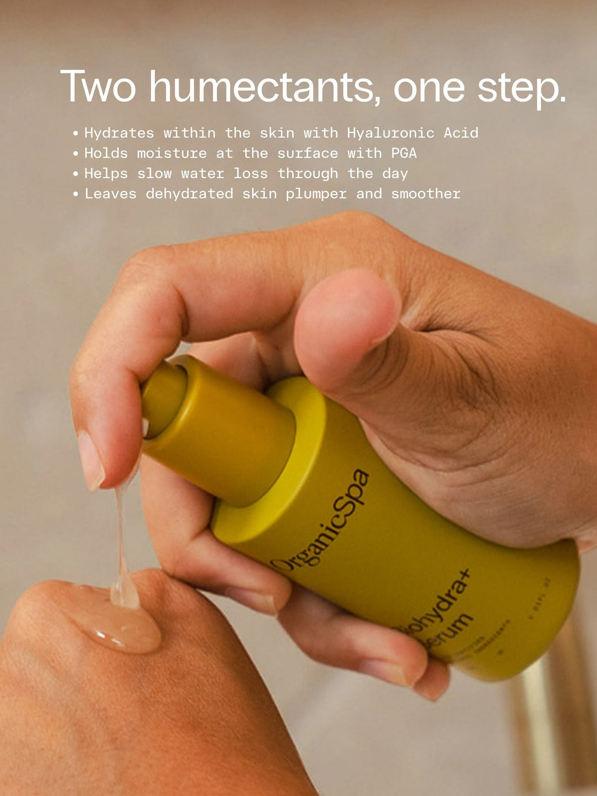 A hand dispensing OrganicSpa BioHydra+ Serum, a Certified Organic hydrating serum with Hyaluronic Acid and Polyglutamic Acid for dehydrated skin.