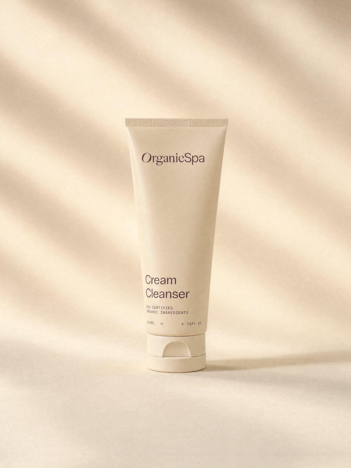 OrganicSpa Cream Cleanser, a sand-coloured 200ml tube marked 82% Certified Organic Ingredients, on a plain background.