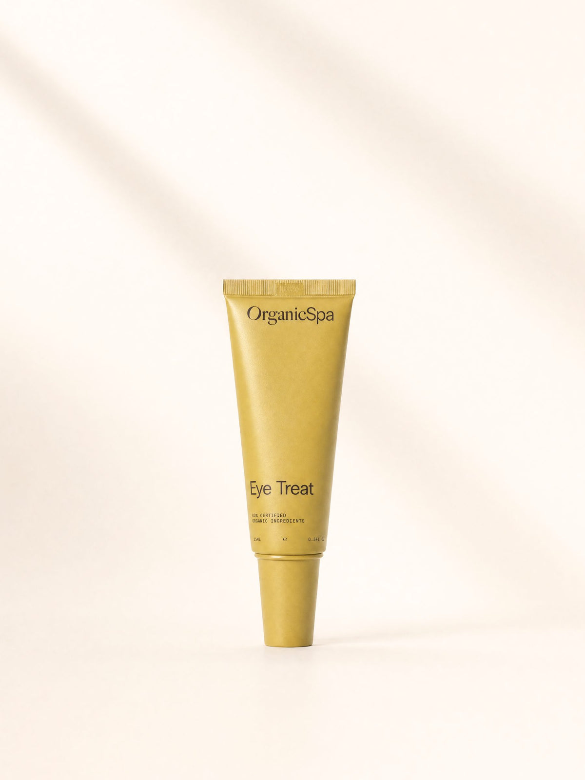 OrganicSpa Eye Treat, a chartreuse 15ml tube marked 83% Certified Organic Ingredients, on a plain cream background.