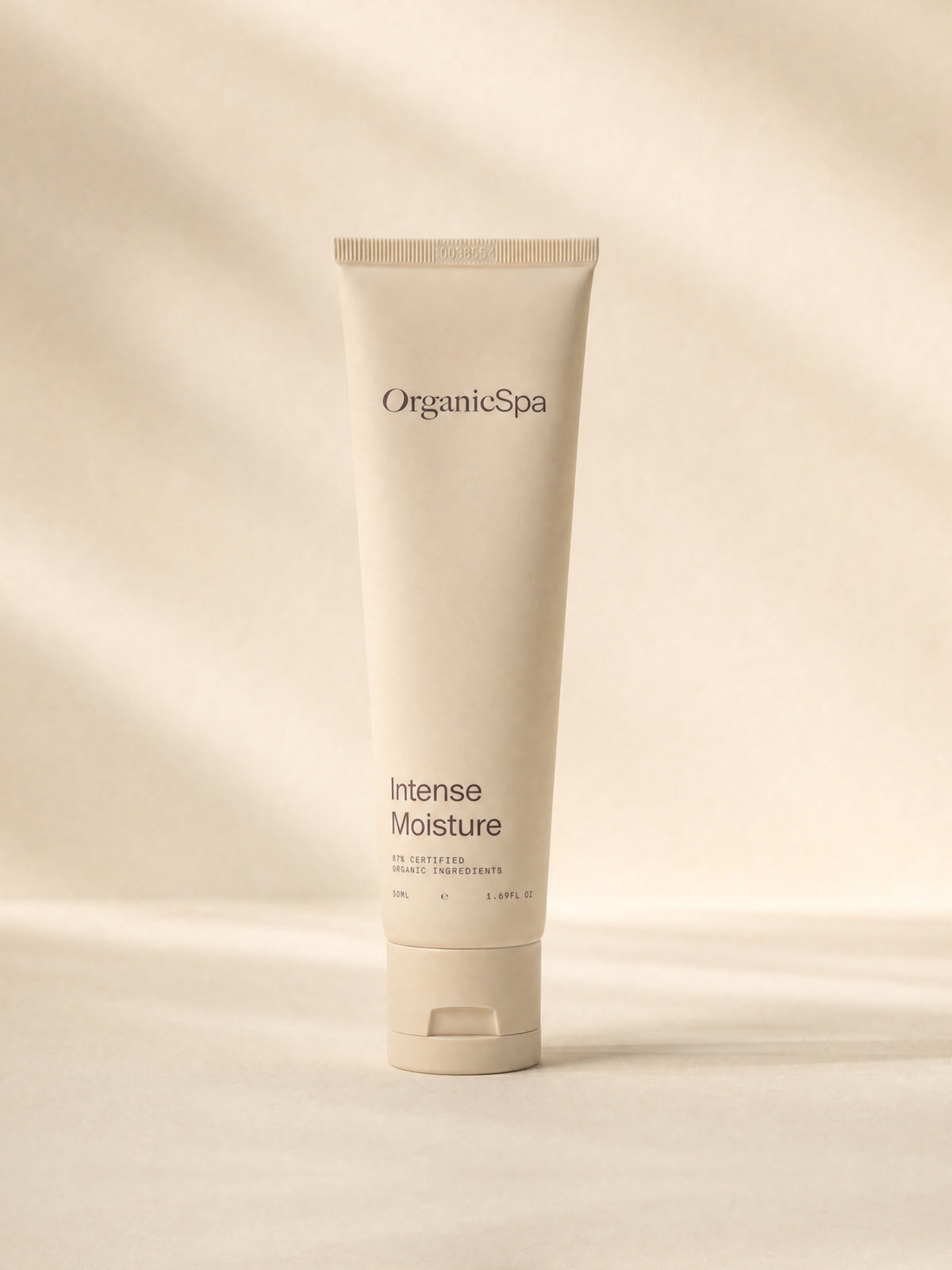 OrganicSpa Intense Moisture, a sand-coloured 50ml tube marked 87% Certified Organic Ingredients, on a plain background.
