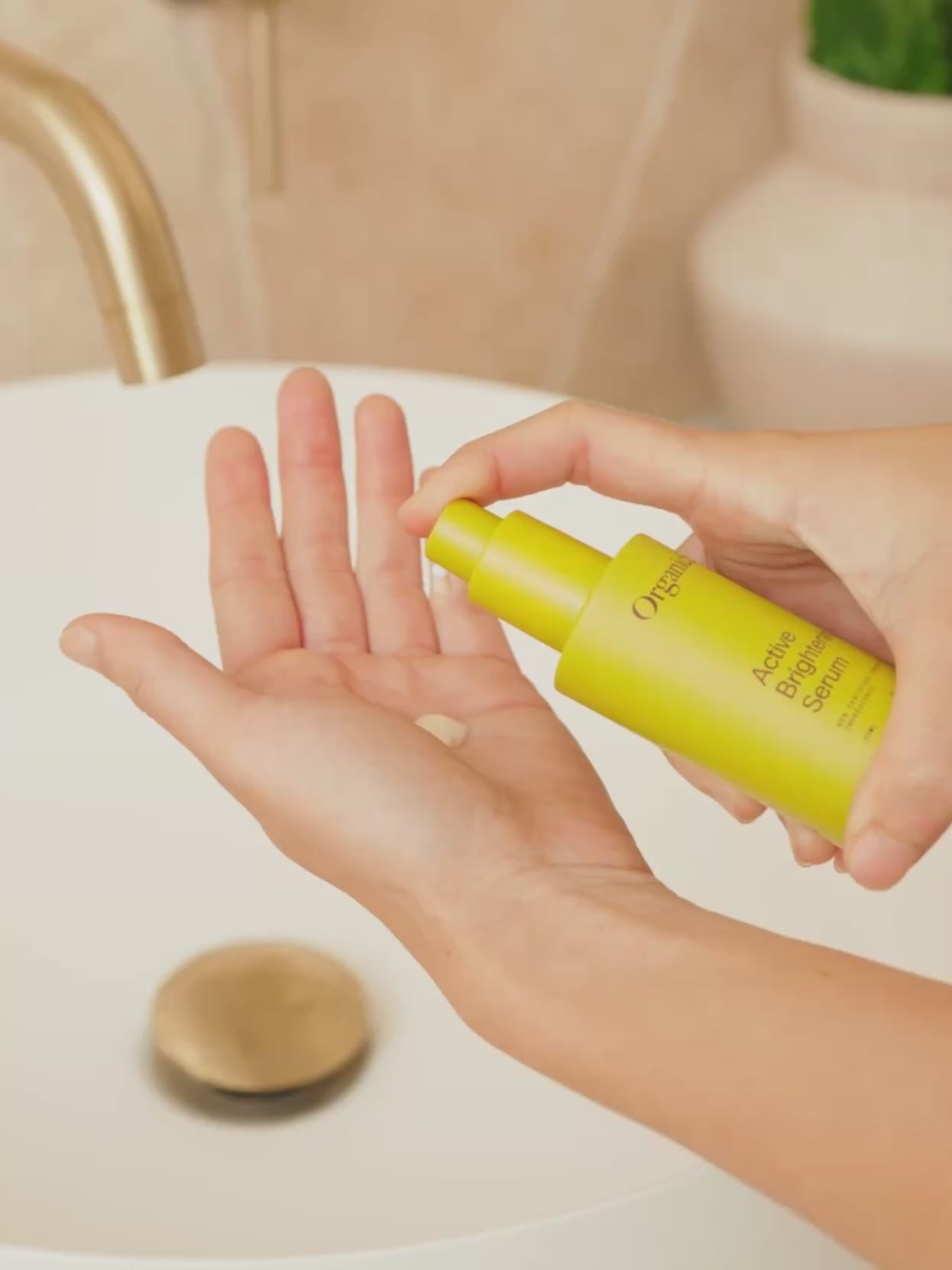 lose-up video of OrganicSpa Active Brightening Serum being pumped onto fingertips then gently pressed into the skin. Certified Organic Skincare.