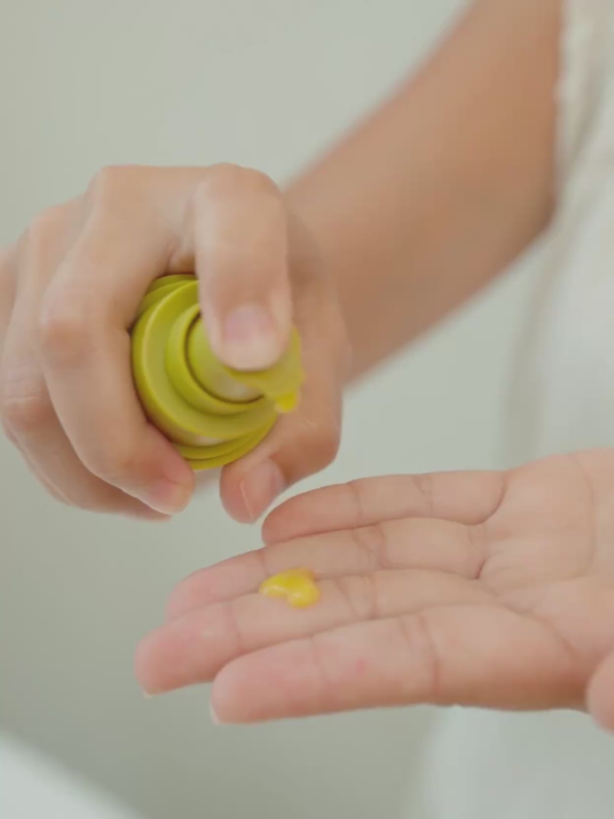 Close-up video showing OrganicSpa Vita-A+CE Complex being dispensed into a palm, then gently applied around the eye area and cheek. The golden serum texture is visible on skin. Ends on a styled product shot of the Vita-A+CE Complex bottle on a stone surface. Certified Organic Skincare.